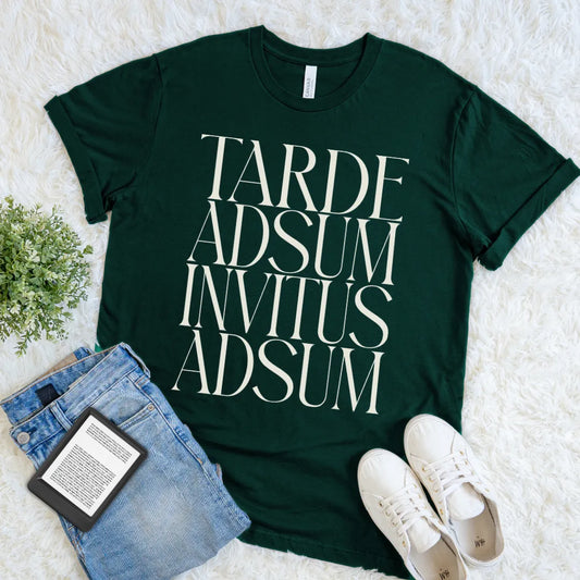 Forest green Tarde Adsum Invitus Adsum Latin quote T-shirt with oversized cream serif typography, a funny dark academia tee for introverts and classics lovers.
