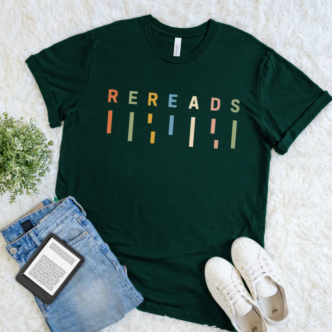 Forest green retro bookish tee featuring colorful Rereads typography for readers who return to favorite stories.