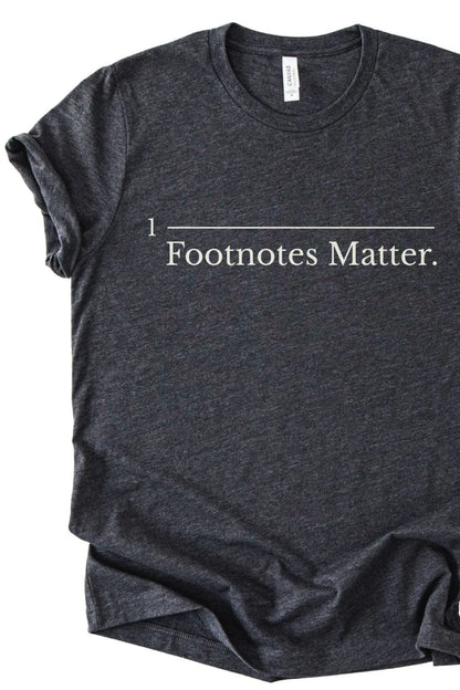 Dark gray book humor t-shirt with 'Footnotes Matter.' text on a white background
