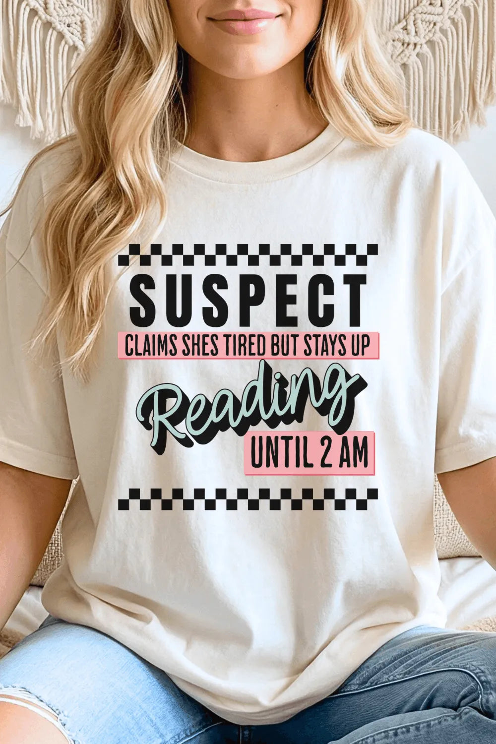 Woman wearing Funny bookworm aesthetic t-shirt with reading until 2AM quote and playful typography for cozy reader outfits