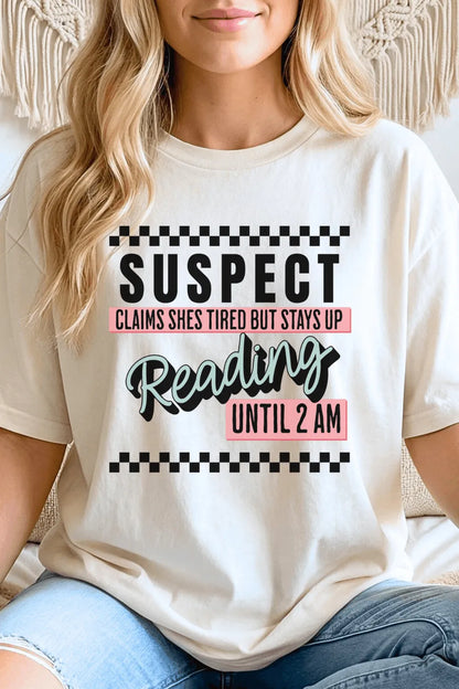 Woman wearing Funny bookworm aesthetic t-shirt with reading until 2AM quote and playful typography for cozy reader outfits