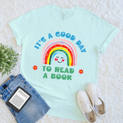 Heather ice blue shirt with a  cheerful rainbow graphic with reading-themed message