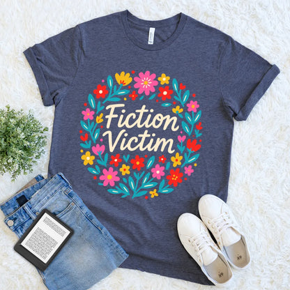 Literary t-shirt with playful floral circle and  funny bookish quote "fiction victim" in heather navy