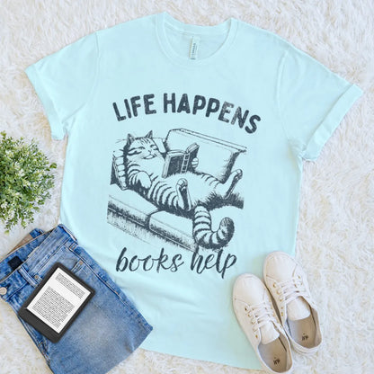 heather ice blue t-shirt with illustration of cat holding book with cozy quote