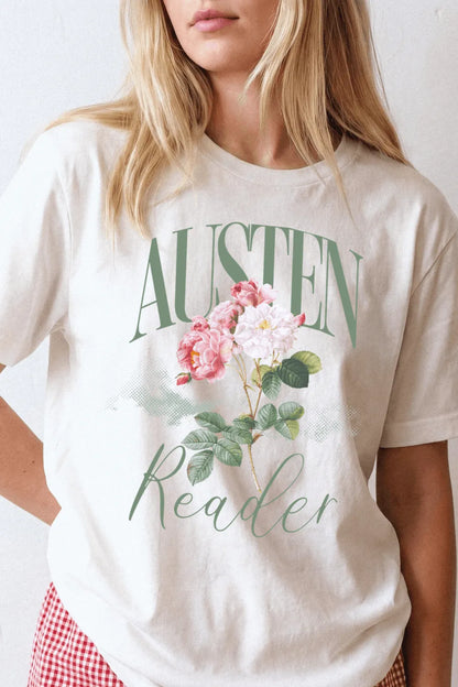 woman wearing a cream literary graphic t-shirt with “Austen Reader” typography and vintage pink floral illustration, styled for feminine bookish outfits