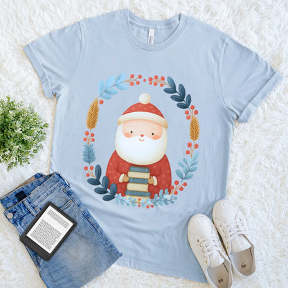 Cute Christmas graphic t-shirt design with Santa holding books and festive foliage