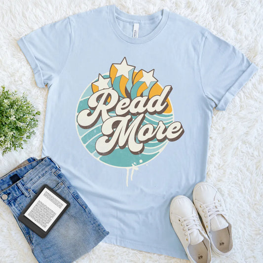 light blue graphic tee with colorful burst and reading slogan read more