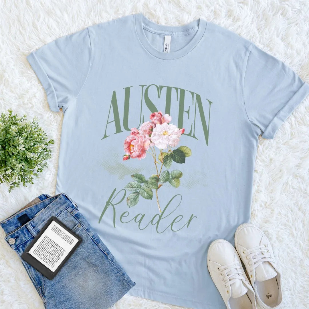 Soft cotton literary shirt with botanical pink blooms and minimalist green typography layout on light blue cotton