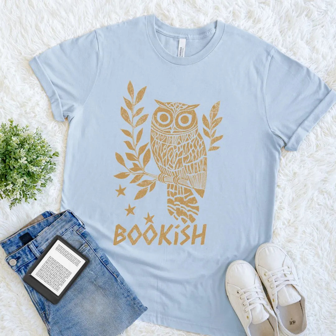 book lover graphic t-shirt with vintage woodcut owl illustration and "bookish" text in gold on light blue cotton