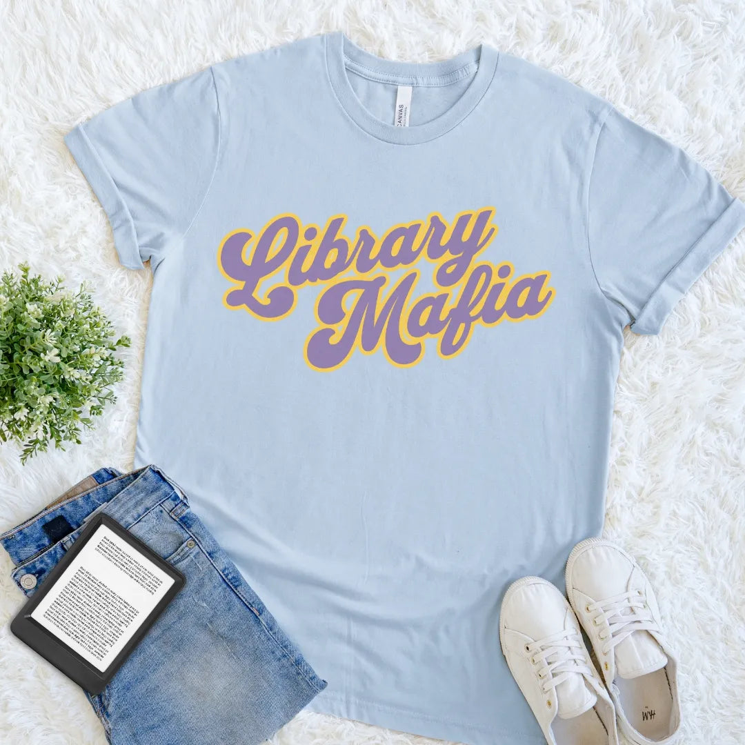 Light Blue book lover tee featuring playful Library Mafia lettering and a colorful vintage-inspired design