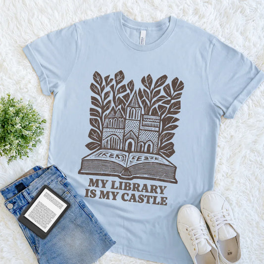Soft cotton reader shirt with My Library Is My Castle quote and book artwork on light blue cotton