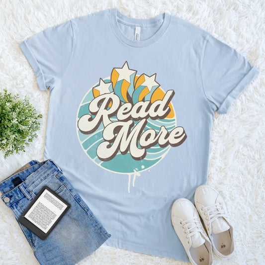 light blue graphic tee with colorful burst and reading slogan read more