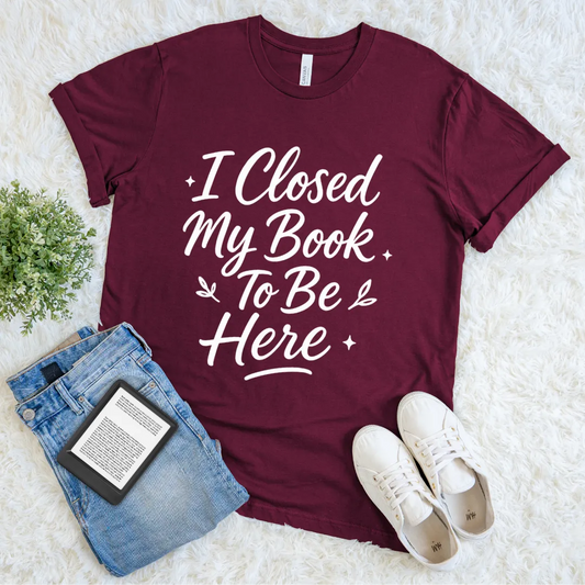Cozy reader tee featuring bold bookish typography in maroon red 