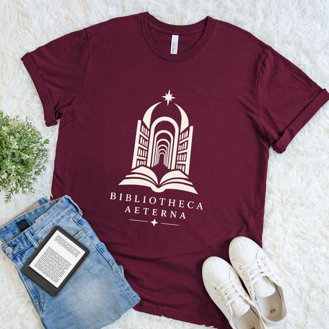 Maroon Bibliotheca Aeterna shirt with an open book leading into an endless celestial library