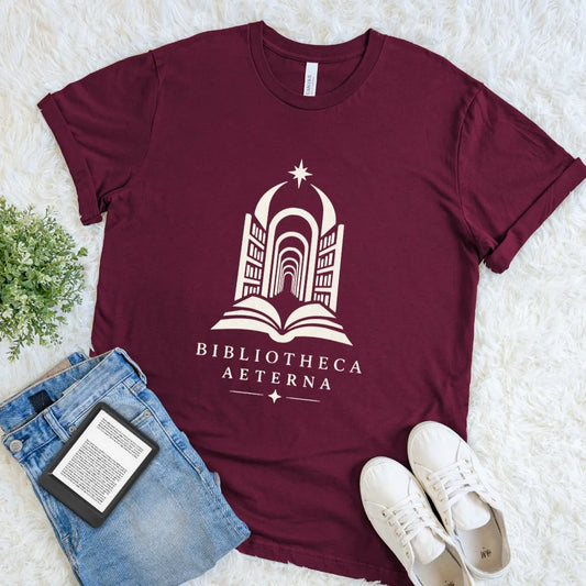 Maroon Bibliotheca Aeterna shirt with an open book leading into an endless celestial library
