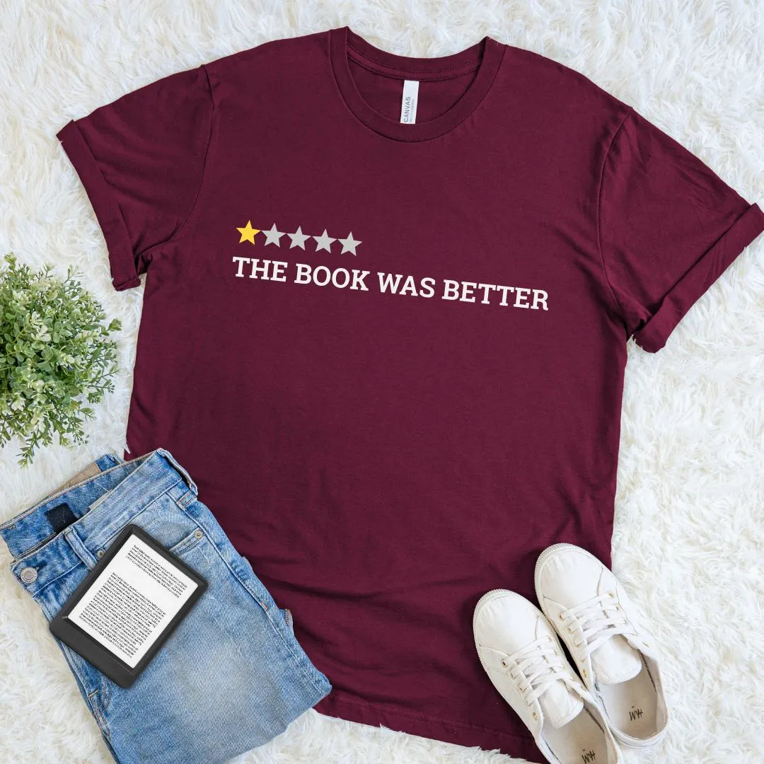 Cozy book lover T-shirt featuring humorous book quote and simple graphic layout on maroon cotton