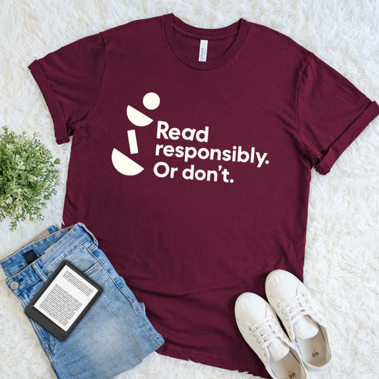 Maroon Read Responsibly Or Don’t literary humor T-shirt with crisp typography and geometric accents, a playful reader shirt for book lovers.