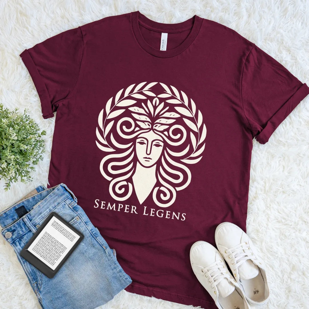 Maroon Semper Legens T-shirt with a stylized woman, curling ram horns, leafy crown, and cream Latin lettering