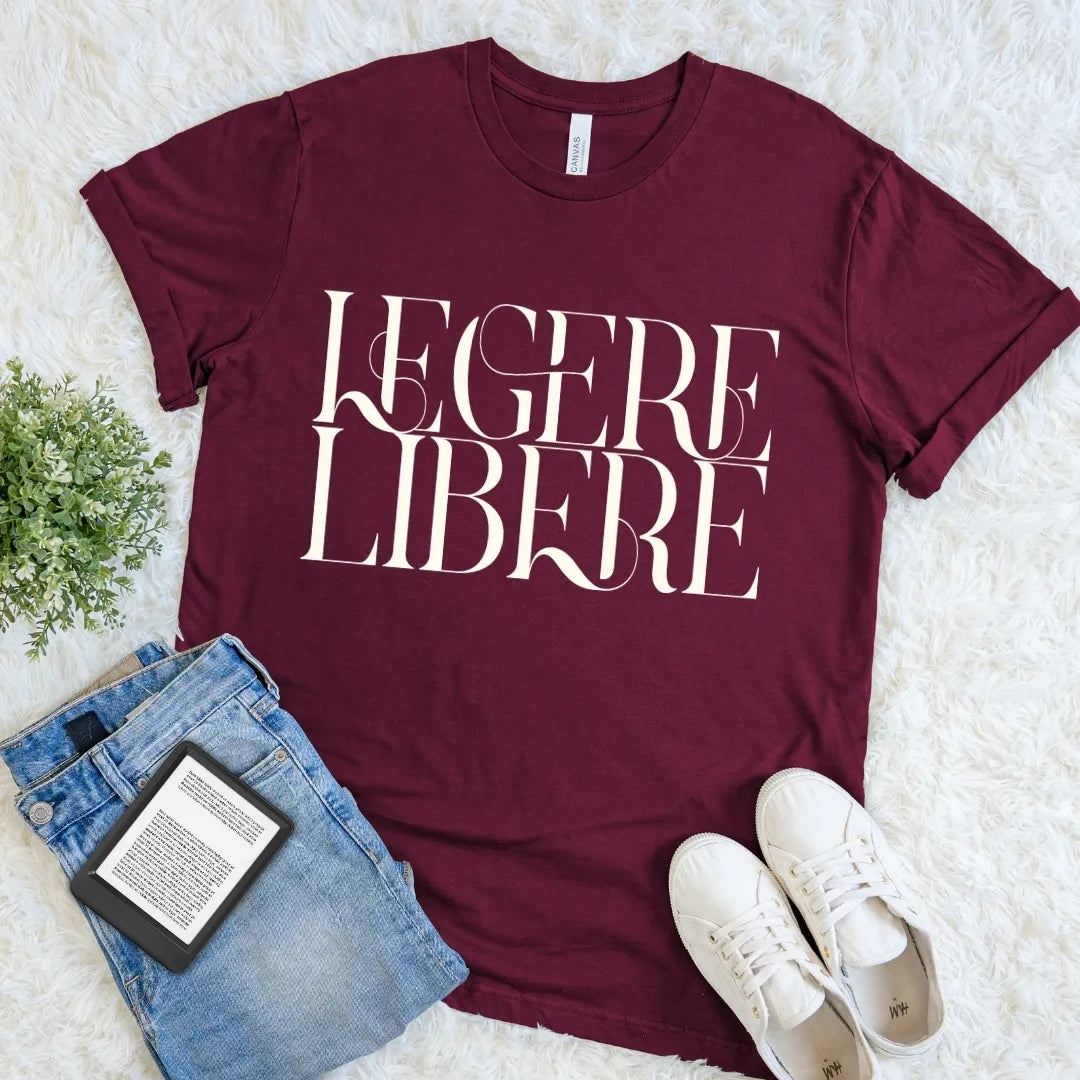 Maroon Legere Libere Read Freely bookish T-shirt with large cream serif lettering, a dark academia Latin quote shirt for devoted readers.