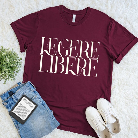 Maroon Legere Libere Read Freely bookish T-shirt with large cream serif lettering, a dark academia Latin quote shirt for devoted readers.