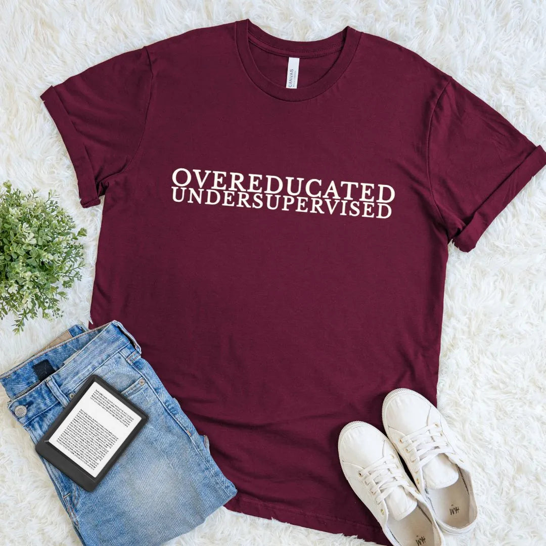 Literary T-shirt with Overeducated Undersupervised text on maroon red cotton