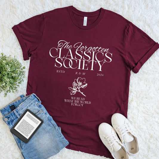 Maroon Forgotten Classics Society reader T-shirt with elegant cream typography, floral accents, and “We Read What the World Forgot,” a dark academia book lover shirt inspired by forgotten literature.