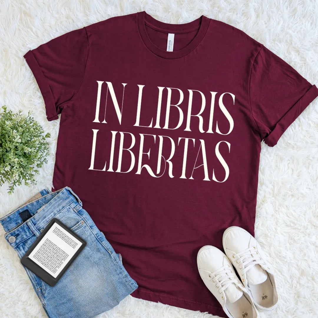 Maroon book lover T-shirt with “In Libris Libertas” Latin quote, dark academia literary graphic tee for readers, librarians, and classic literature lovers.