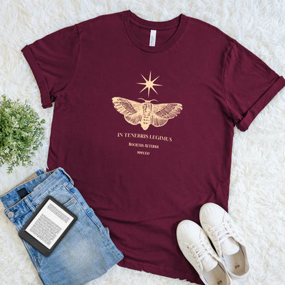 Minimal gold moth print and latin quote on maroon t-shirt for an understated, intellectual aesthetic.