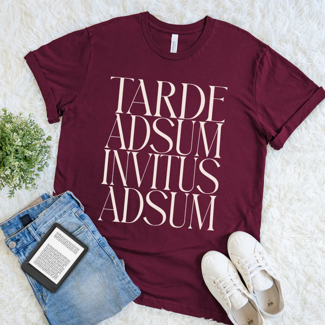 Maroon Tarde Adsum Invitus Adsum Latin quote tee with oversized cream serif lettering, a witty introvert T-shirt for classics lovers and bookish minds.