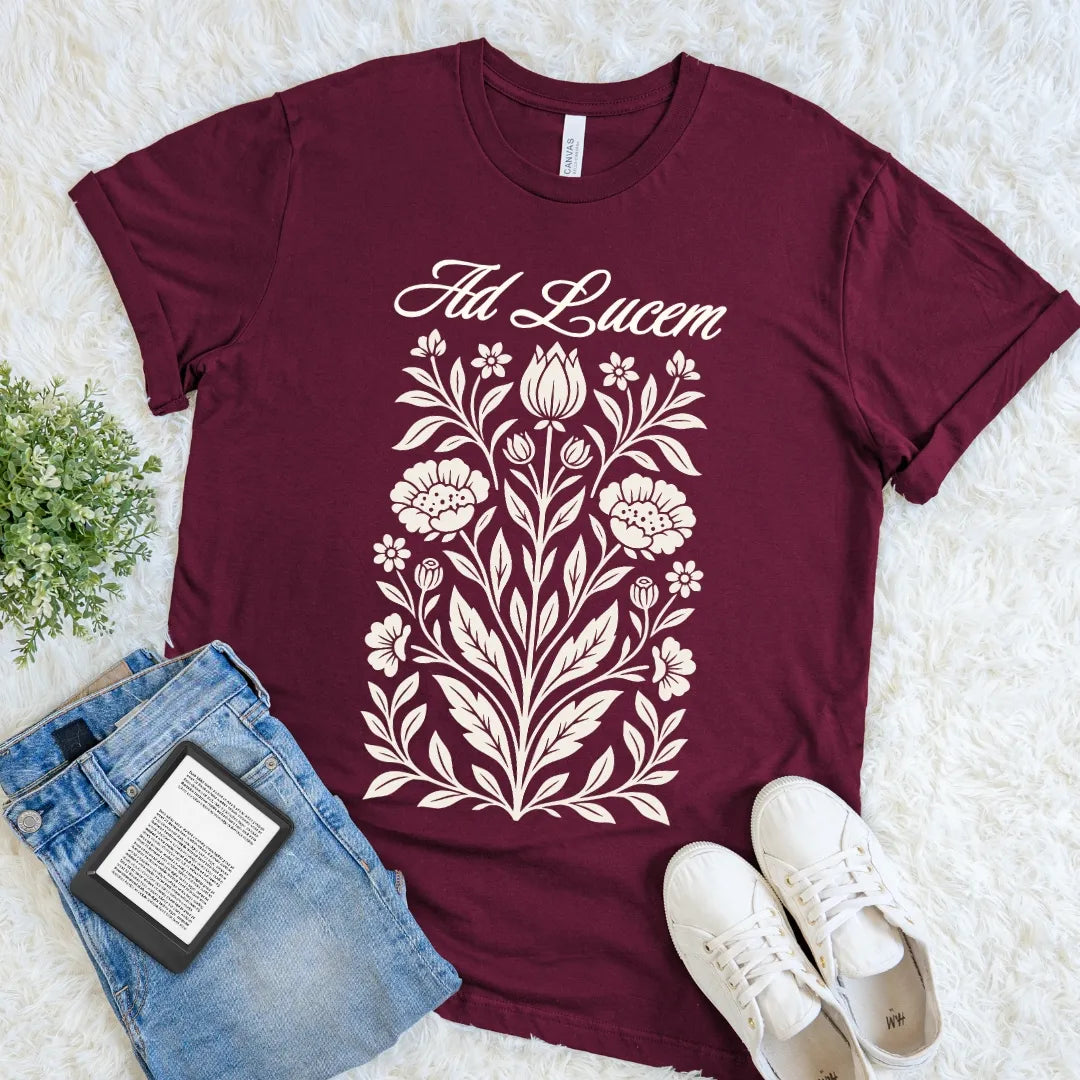 Maroon Ad Lucem Latin T-shirt with abundant vintage botanical illustration and graceful lettering, a romantic dark academia statement tee meaning toward the light.