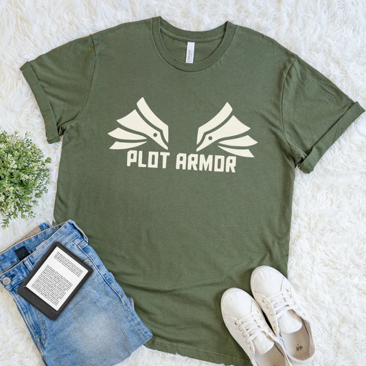Flat lay of military green fantasy reader T-shirt with Plot Armor text and wing-inspired graphic