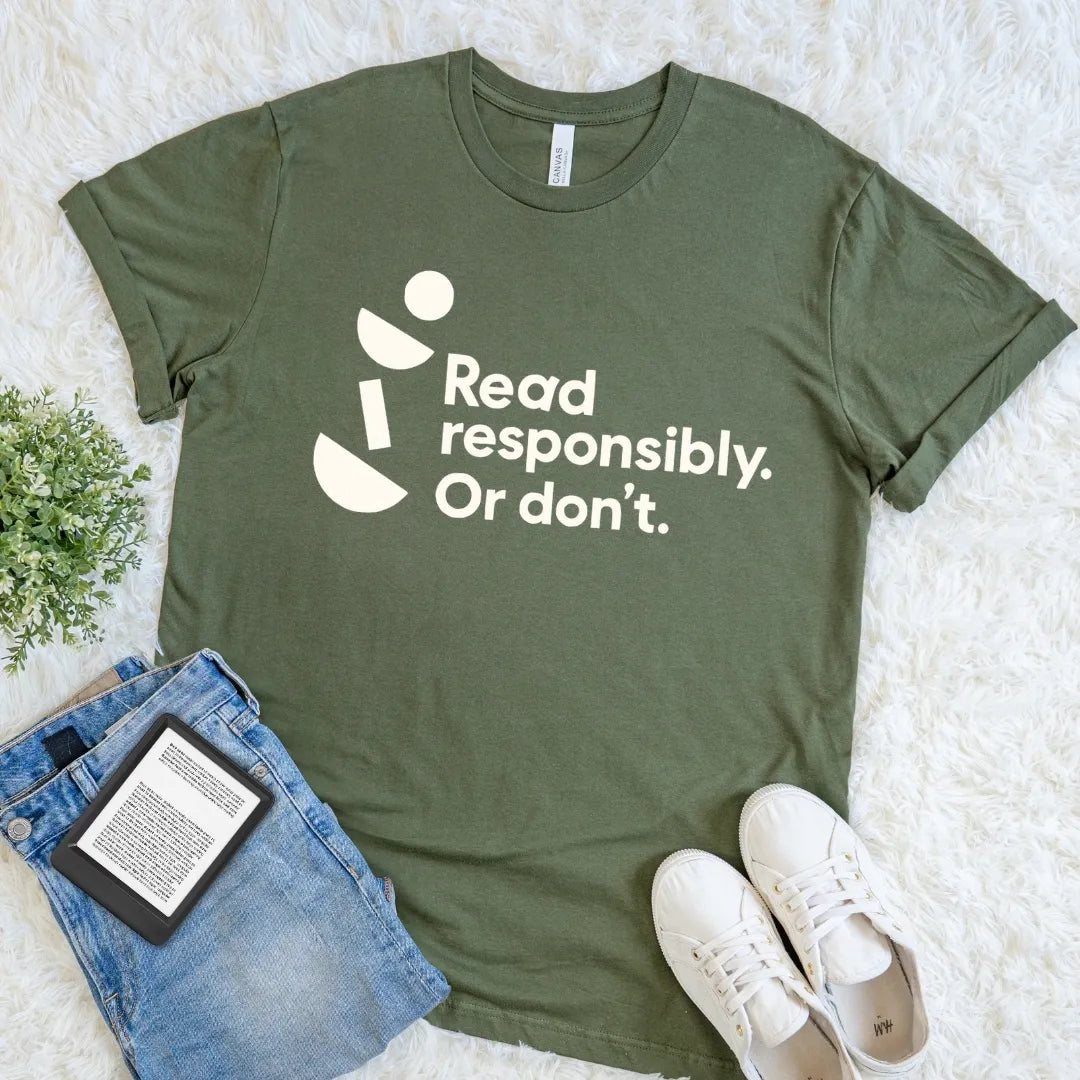 Military Green Read Responsibly Or Don’t reader T-shirt featuring clean typography and playful geometric accents, a casual book lover graphic tee.