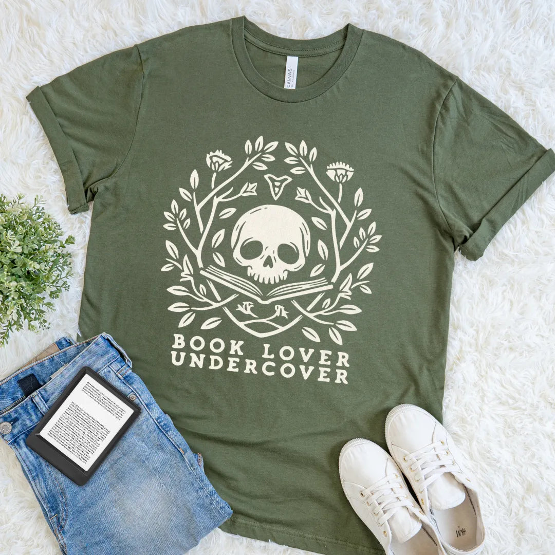 Military Green Book Lover Undercover tee with vintage botanical details and a secret-reader memento mori design