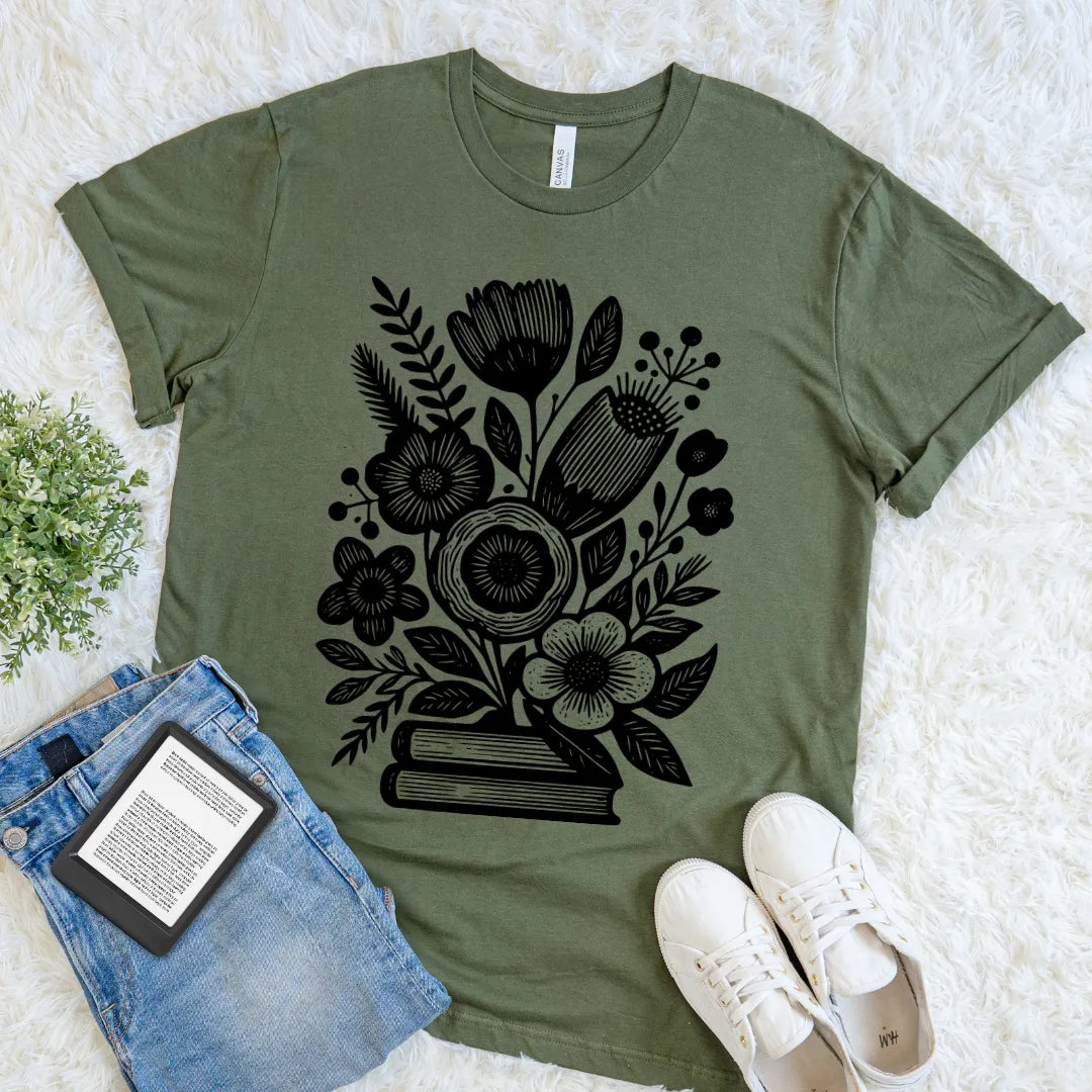 Green cozy literary shirt with black blooming flowers and book stack line art design
