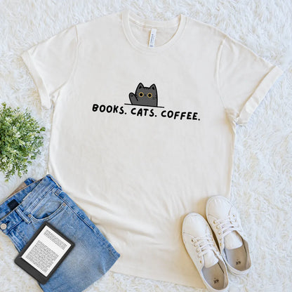 Cream T-shirt with black cat and “Books. Cats. Coffee.” text