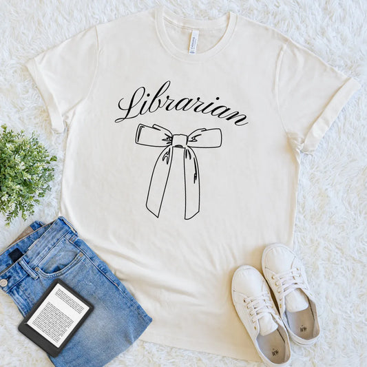 cream-colored t-shirt with “Librarian” in script and minimalist bow