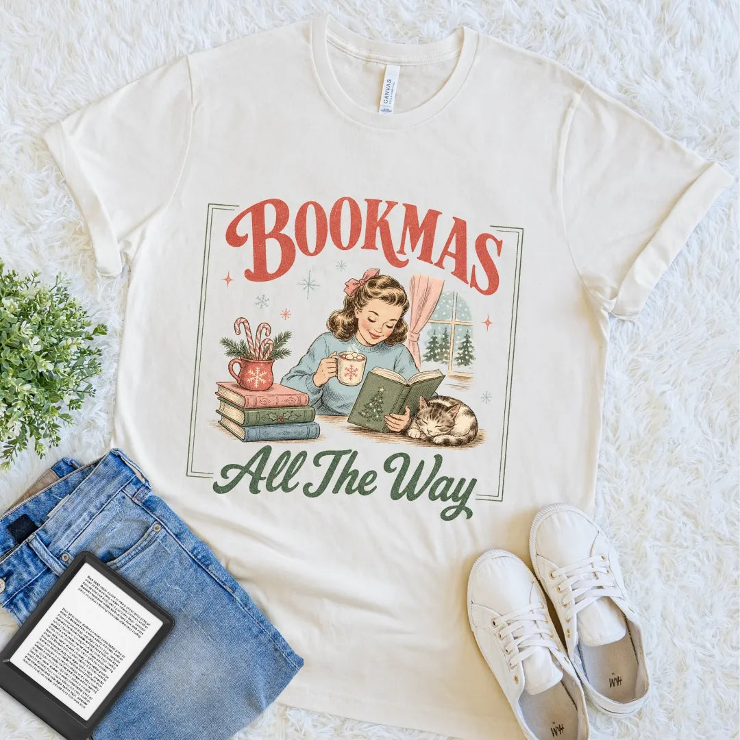 Festive literary graphic tee for readers who prefer books, cats, and warm drinks during the holiday season.