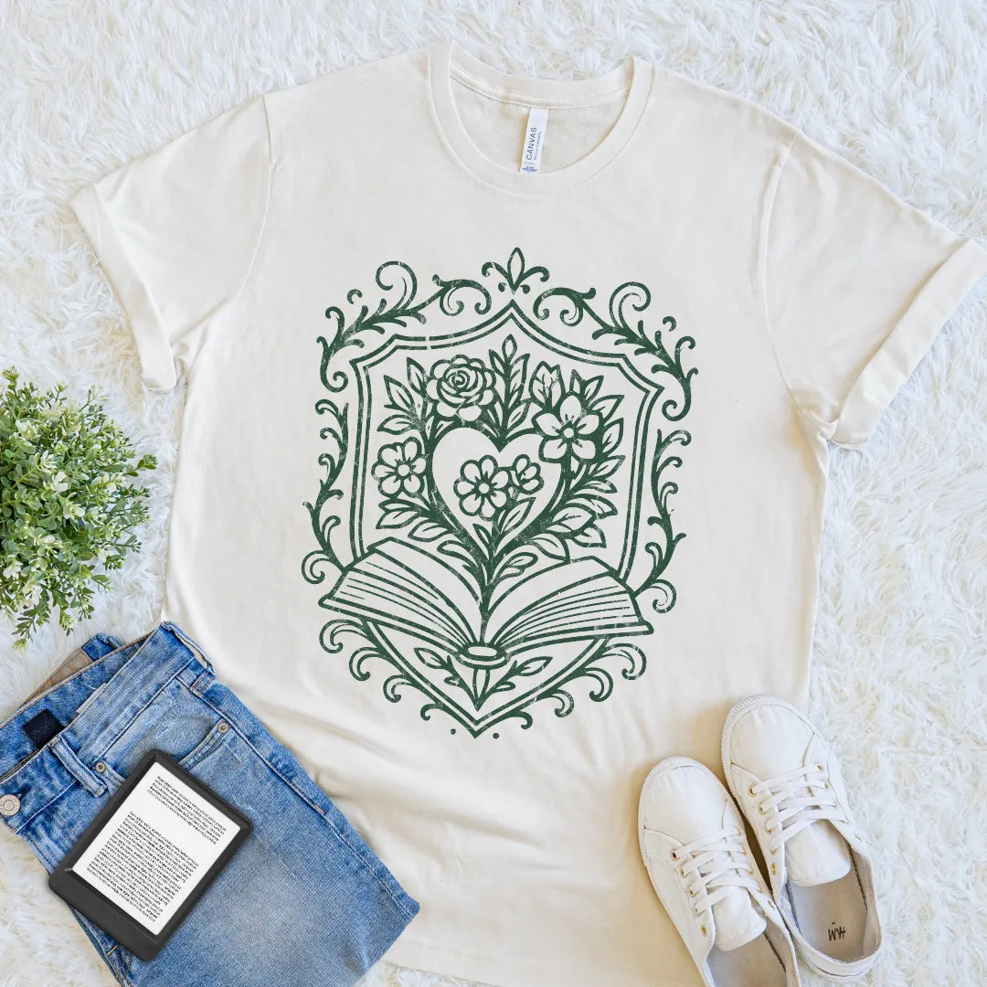 Vintage-style reader shirt featuring ornate frame with flowers and open book graphic on natural beige cotton