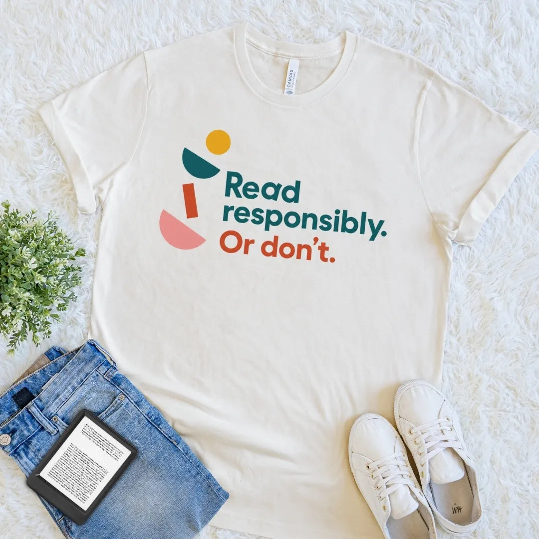 Natural Read Responsibly Or Don’t reader T-shirt with colorful retro-inspired typography and playful geometric details, a cheerful bookish graphic tee.