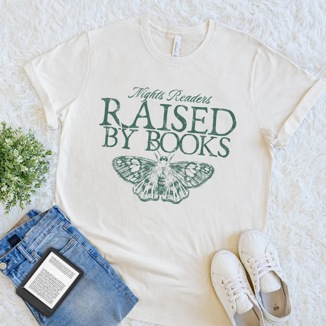 Cream book lover T-shirt with Raised by Books text and vintage moth  illustration