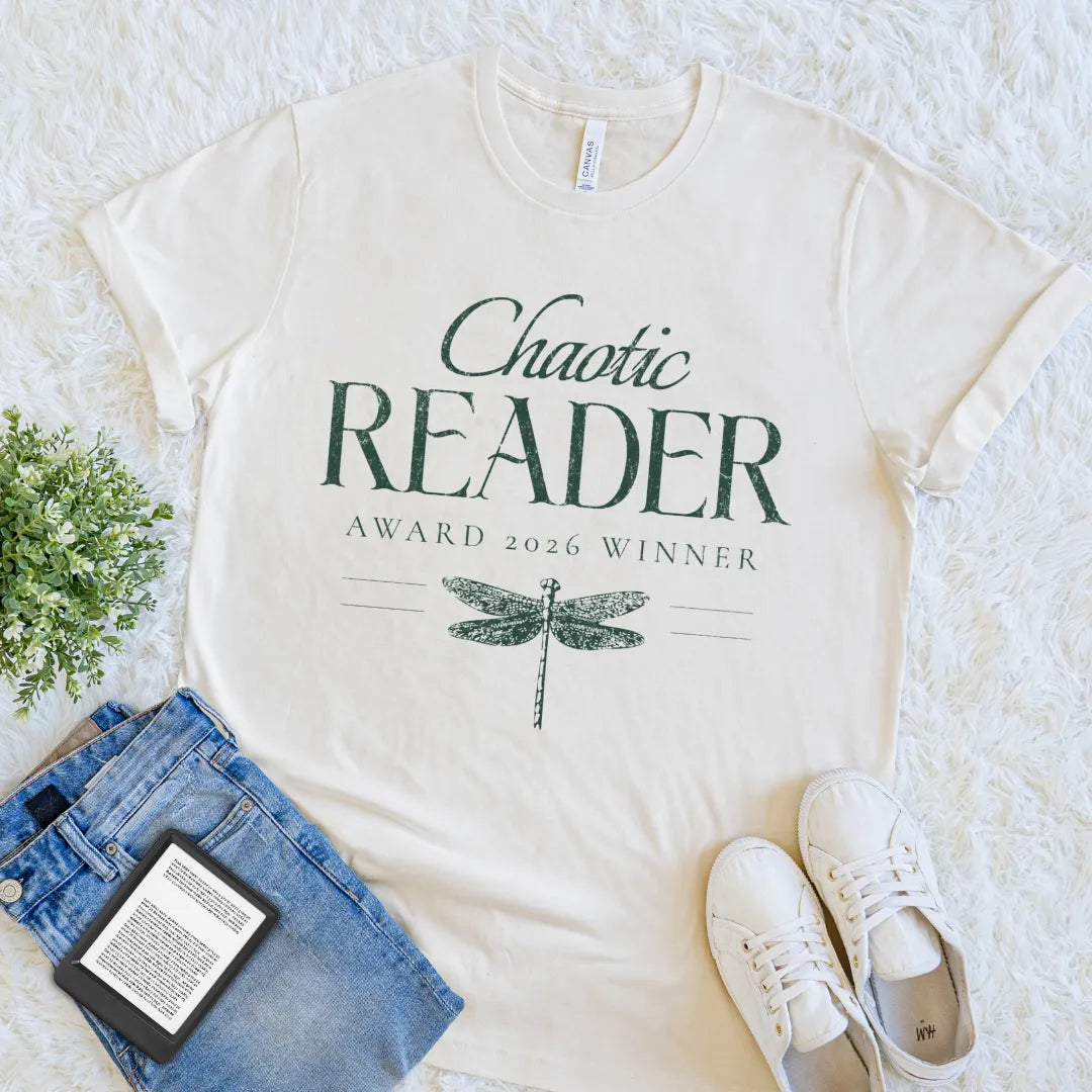 Cream book lover T-shirt with Chaotic Reader text and dragonfly illustration flat lay