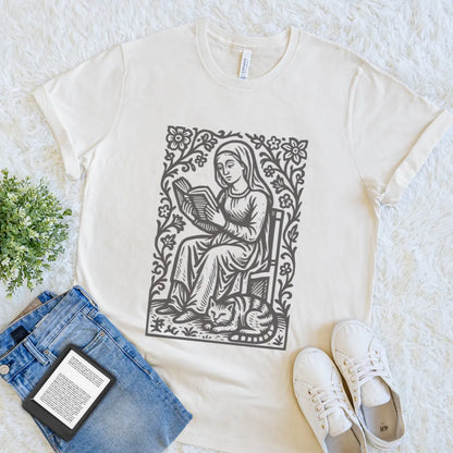 Cozy reader shirt featuring floral vintage artwork of woman reading a book with cat on natural beige cotton