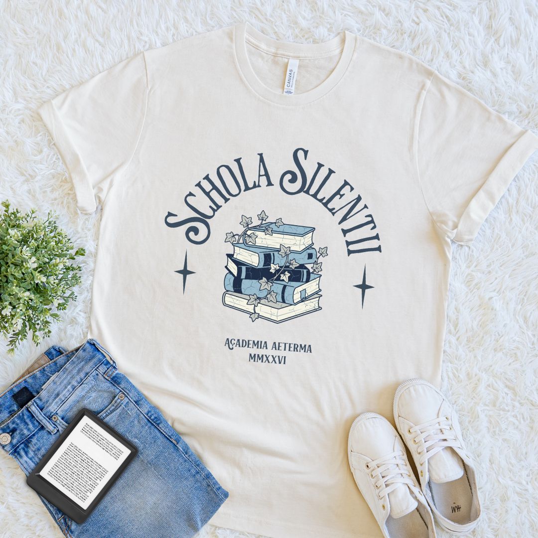 natural beige bookish T-shirt with Schola Silentii text and stacked books illustration in dark academia style