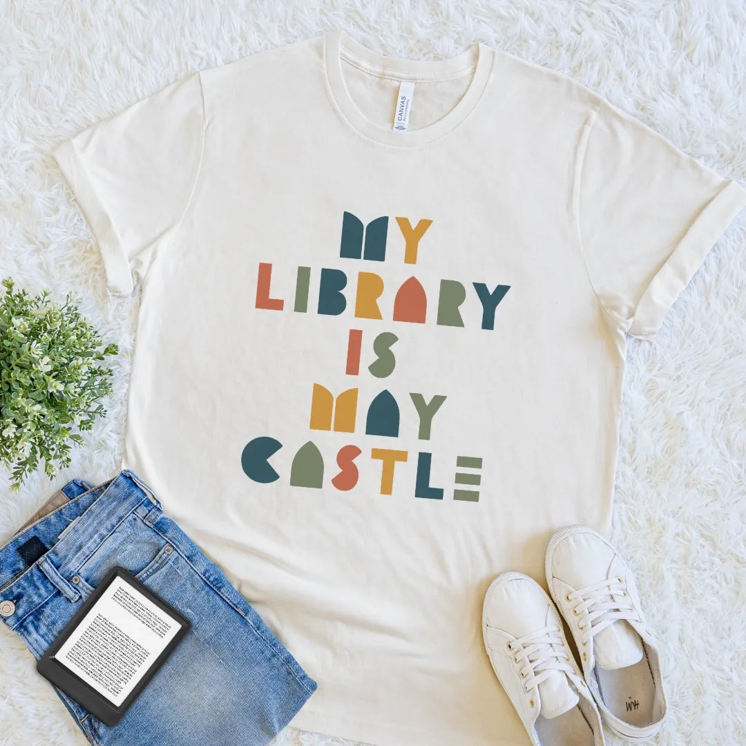 Natural reader shirt featuring colorful My Library Is My Castle lettering in a retro geometric design.