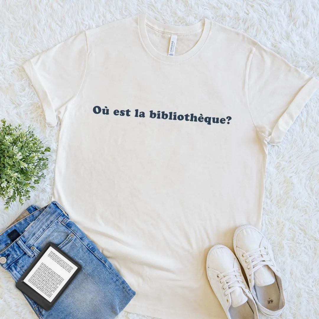 Cream bookish T-shirt featuring Où Est La Bibliothèque French reader quote