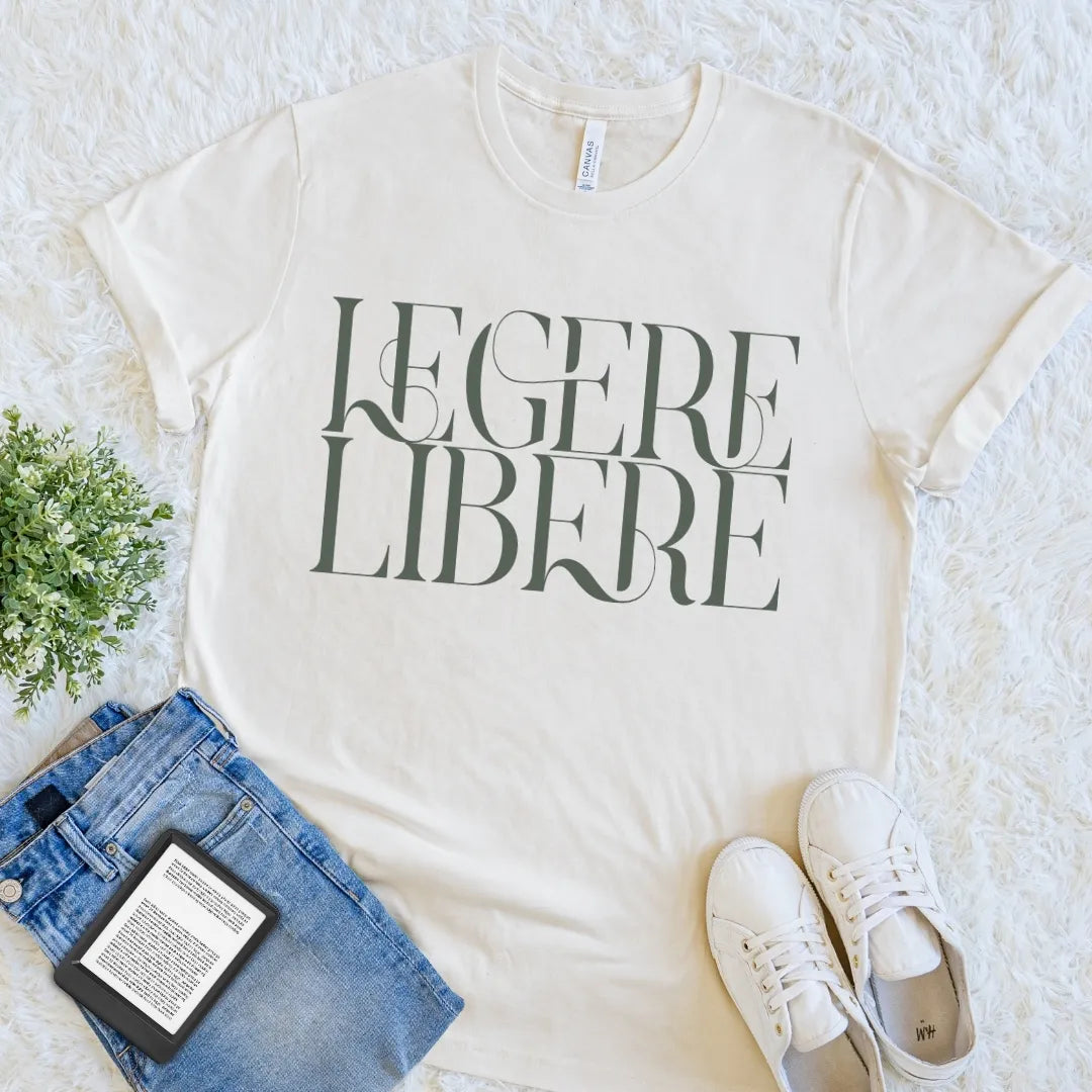 Natural Legere Libere Read Freely reader T-shirt featuring bold editorial typography, a minimalist Latin quote graphic tee for literary style.