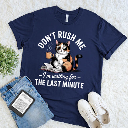 flat lay of soft cotton navy t-shirt featuring introvert deadline humor for readers quote and cat reading a book  design