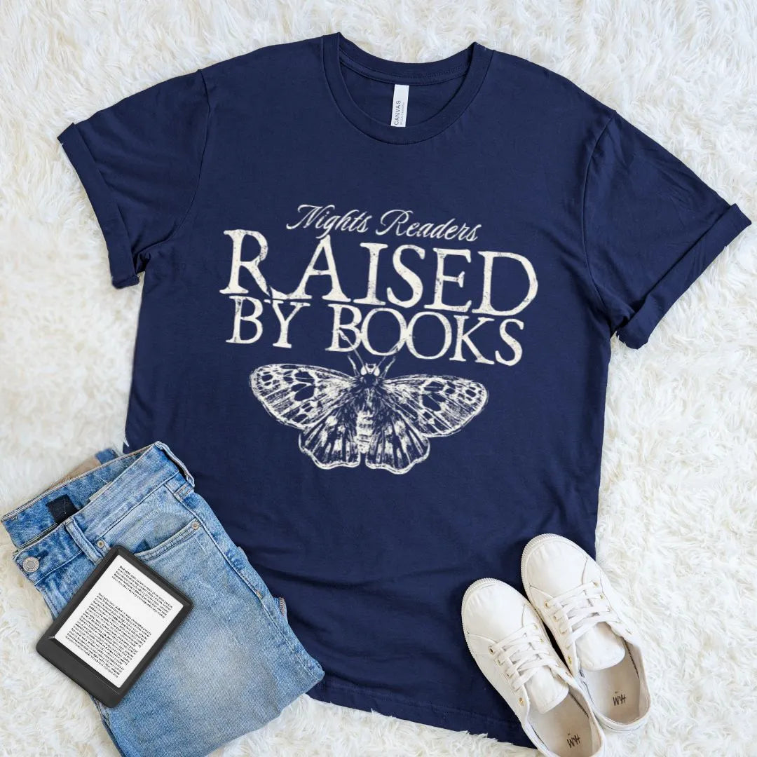 Bookish t-shirt with 'Nights Readers Raised by Books' text and butterfly graphic on navy blue cotton