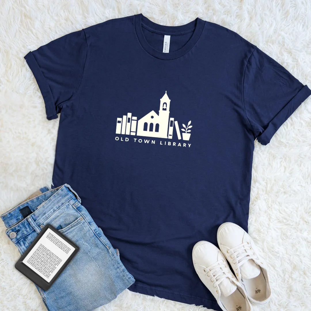 Soft reader shirt with vintage library illustration and book stack design on navy cotton 