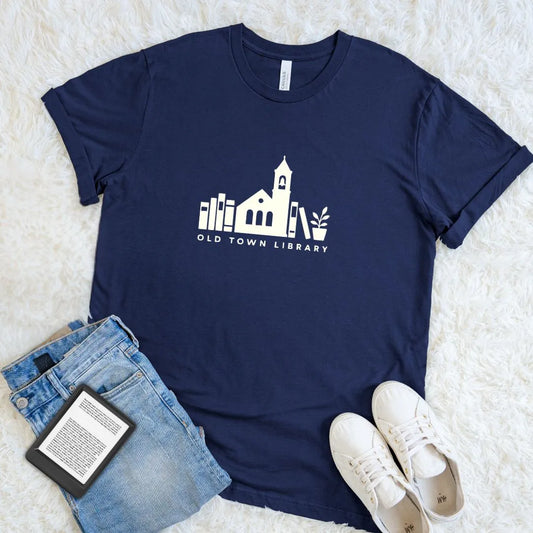 Soft reader shirt with vintage library illustration and book stack design on navy cotton 